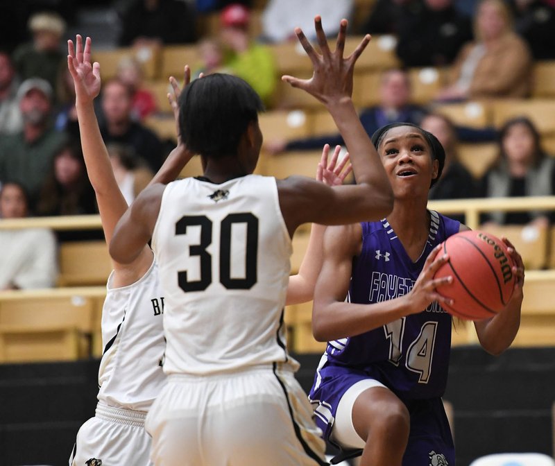 NWA Democrat-Gazette/J.T. WAMPLER Fayetteville's Coriah Beck eyes the basket while Bentonville's Maryam Dauda defends Tuesday Jan. 15, 2019 at Tiger Stadium in Bentonville. Fayetteville won 41-40.