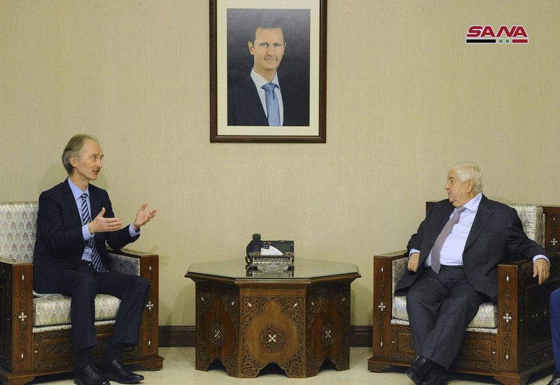 In this photo released by the Syrian official news agency SANA, Syria's Foreign Minister Walid al-Moallem, right, meets with the United Nations' new special envoy for Syria, Geir Pedersen, in Damascus, Syria, Tuesday, Jan. 15, 2019. 