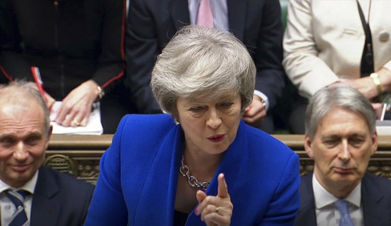 Britain's Prime Minister Theresa May speaks during Prime Minister's Questions in the House of Commons, London, Wednesday Jan. 16, 2019. In a historic defeat for the government Tuesday, Britain's Parliament discarded May's Brexit deal to split from the European Union, and May now faces a parliamentary vote of no-confidence later Wednesday. (House of Commons/PA via AP)