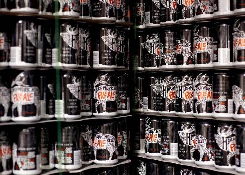 Empty cans are seen on Wednesday, July 9, 2014, at Ozark Beer Company in Rogers. The brewery has announced a new beer and an annual scholarship in honor of former Rogers Heritage High School employee Brig Caldwell. STAFF PHOTO, JASON IVESTER.