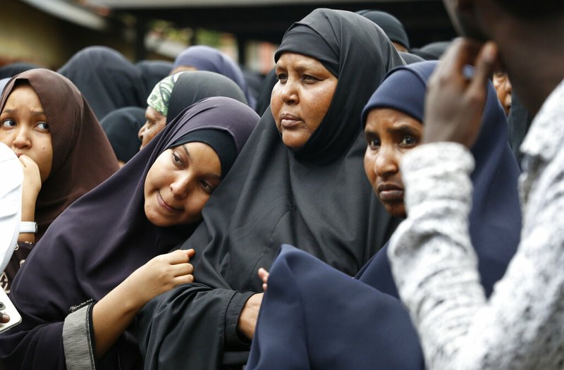 Family members including the mother of Abdalla, center, prepare to pray over the bodies of Abdalla Dahir and Feisal Ahmed, who were both killed in Tuesday's attack, at a mosque in Nairobi, Kenya Wednesday, Jan. 16, 2019. The two worked for the Somalia Stability Fund, managed by the London-based company Adam Smith International, and were killed in Tuesday's assault by Islamic extremist gunmen on a luxury hotel and shopping complex. (AP Photo/Brian Inganga)