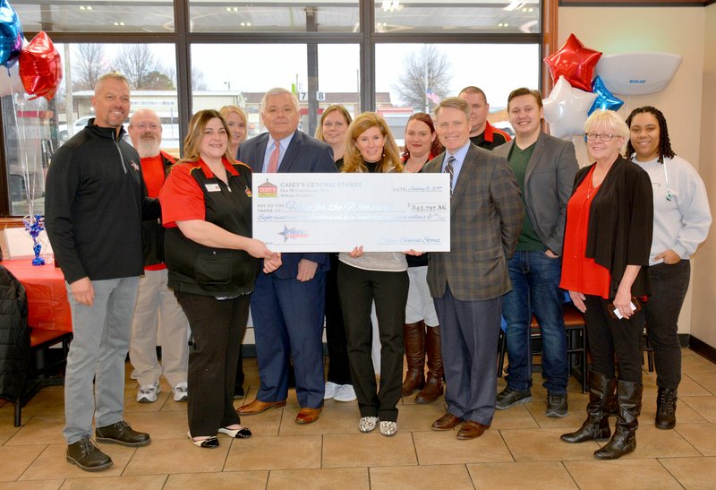 Casey’s General Store corporate officials presented a check for $845,797.86, the entire company’s donation to Hope For The Warriors. Casey’s Siloam Springs store was the leading fundraiser for the company, bringing in $7,580. Pictured, from left, are John Langford, senior director of strategic partnerships for Hope For The Warriors; Robert Brown, Siloam Springs Casey’s associate; Randy Toto, Siloam Springs Casey’s store manager; Mike Richardson, vice president of marketing for Casey’s; Linda Dutton, Siloam Springs Casey’s associate; Robin Kelleher, president and CEO Hope For The Warriors; Jackie Davis, Siloam Springs Casey’s associate; Terry Handley, president and CEO Casey’s; Michael Honea, Siloam Springs Casey’s associate; Michael Humprey, Siloam Springs Casey’s associate; Regina Harp, area Casey’s supervisor; and Kiara Page, Siloam Springs Casey’s associate.