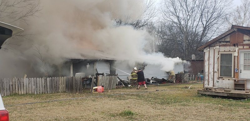 The Sentinel-Record/Grace Brown
Multiple fire departments attack a fully involved structure fire 302 Ninth St. in Mountain Pine Wednesday afternoon.