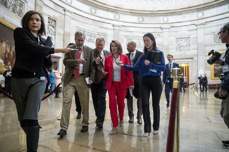 House Speaker Nancy Pelosi leaves a meeting with furloughed workers Wednesday on Capitol Hill as a bipartisan group of senators sought support for a letter calling for an end to the government shutdown. 