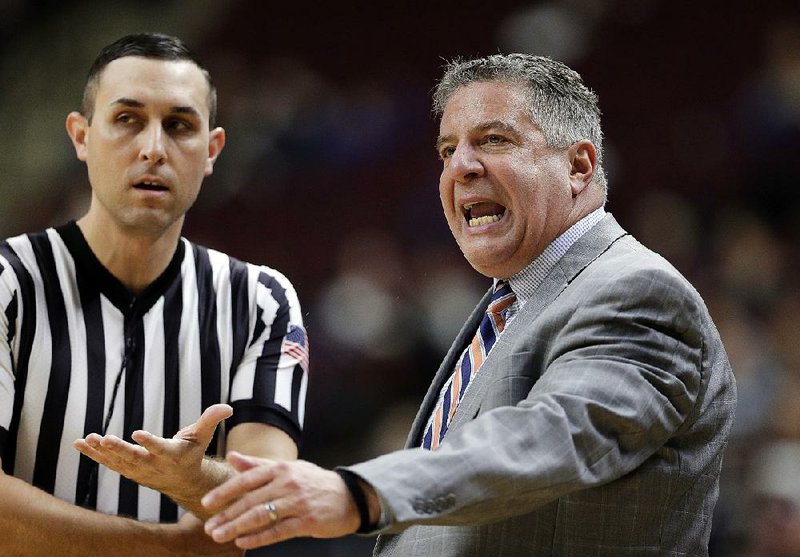 Auburn Coach Bruce Pearl (right) questions an official during the No. 14 Tigers’ 85-66 victory over Texas A&M on Wednesday. 