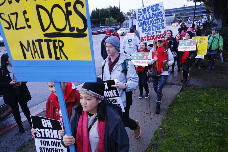 Teachers and students carry signs and picket in front of Hamilton High School, Wednesday, Jan. 16, 2019, in Los Angeles, during a citywide teacher strike. (AP Photo/Richard Vogel)