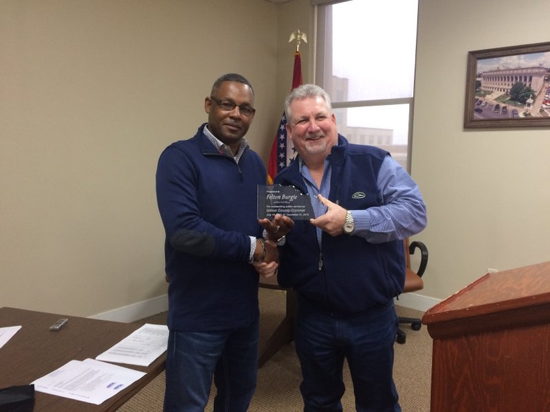 Presentation: Former interim coroner Felton Burgie (left) is presented with a plaque thanking him for his service to Union County by County Judge Mike Loftin at yesterday’s Quorum Court meeting. Caitlan Butler/News-Times