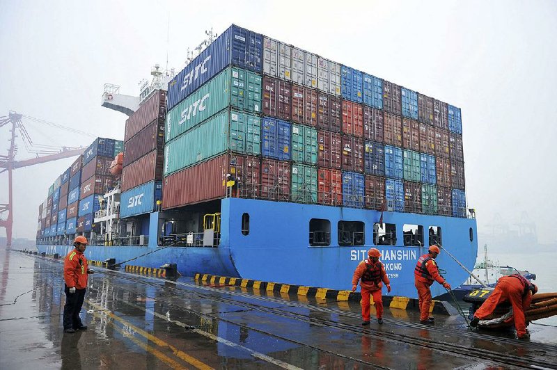 Workers moor a container ship Friday at a port in Qingdao, China. White House officials are debating reductions in tariffs on Chinese goods to help jump-start U.S.-China trade negotiations. 