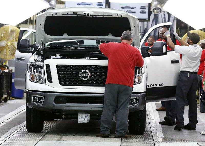 Technicians conduct final inspections on vehicles in March 2018 at the Nissan assembly plant in Canton, Miss. 