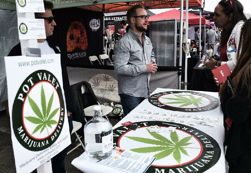 A booth advertises a delivery service for cannabis at a Four Twenty Games event last year in Santa Monica, Calif.