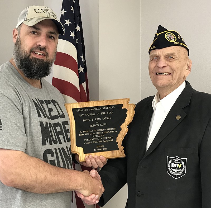 Submitted photo DAV HONOR: Roger Latsha of Arego's Guns receives the DAV Sponsor of the Year Award from William Bucklew, commander of local DAV Chapter 5. The plaque recognizes Roger and Erin Latsha of Arego's Guns.