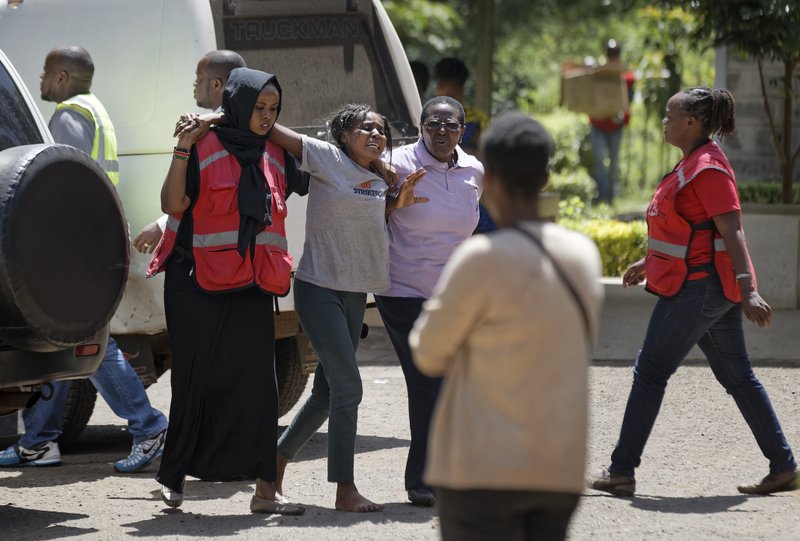 A unidentified relative is helped by Red Cross workers as she grieves after visiting the morgue in Nairobi, Kenya Thursday, Jan. 17, 2019. Extremists stormed a luxury hotel complex in Kenya's capital on Tuesday, setting off thunderous explosions and gunning down people at cafe tables in an attack claimed by Africa's deadliest Islamic militant group al-Shabab. (AP Photo/Ben Curtis)