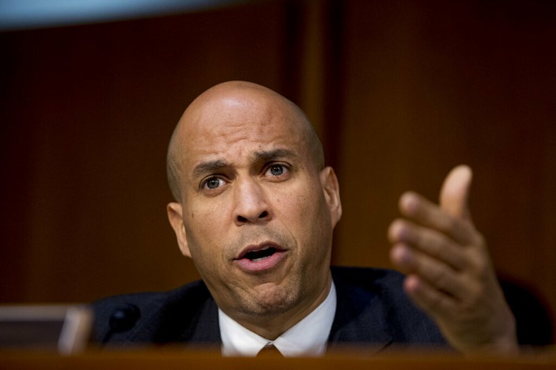 In this Jan. 15, 2019, photo, Sen. Cory Booker, D-N.J., questions Attorney General nominee William Barr as he testifies before a Senate Judiciary Committee hearing on Capitol Hill in Washington. Monday's observance of what would have been Martin Luther King Jr.'s 90th birthday is emerging as an important moment for Democrats eyeing the White House to talk about one of the most divisive issues in politics: race. (AP Photo/Andrew Harnik)