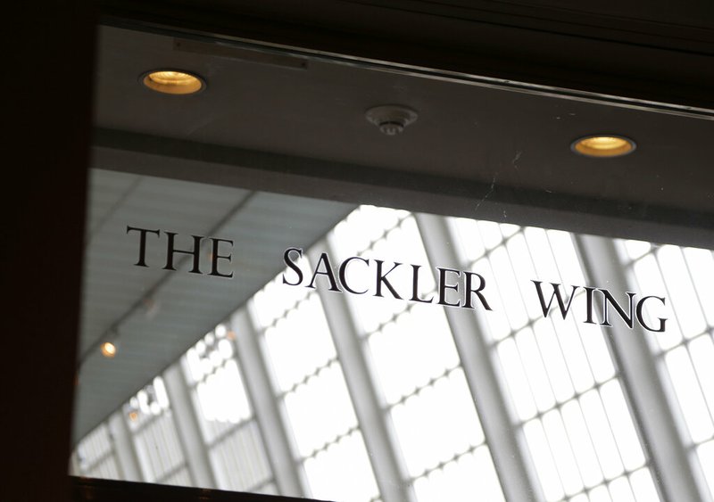 A sign with the Sackler name is displayed at the Metropolitan Museum of Art in New York, Thursday, Jan. 17, 2019. The Sackler name adorns walls at some of the world's top museums and universities, including the Met, the Guggenheim and Harvard. But the family's ties to the powerful painkiller OxyContin and the drug's role in the nation's deadly opioid crisis are bringing a new kind of attention to the Sacklers and their philanthropic legacy. (AP Photo/Seth Wenig)