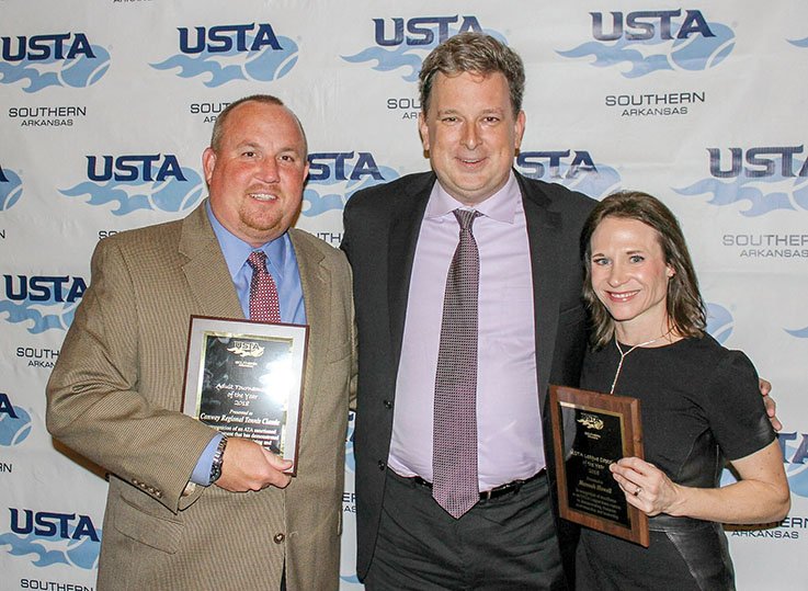 Wyatt Miller of Benton, left, director/facility manager of the Conway Tennis Center, accepts an award from Brad Phelps, president of the United States Tennis Association-Arkansas, for the Conway Regional Tennis Classic winning Adult Tournament of the Year, and Hannah Howell of Conway receives her plaque as the United States Tennis Association-Arkansas’ League Captain of the Year.