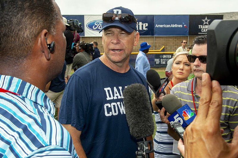  In this July 28, 2018, file photo, Dallas Cowboys offensive coordinator Scott Linehan talks with the media after morning practice at NFL football training camp, in Oxnard, Calif. Scott Linehan is out as offensive coordinator of the Dallas Cowboys only days after coach Jason Garrett sent mixed messages about the oft-criticized assistant's future. 