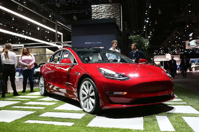 A Tesla Model 3 is displayed before the start of the Los Angeles Auto Show in November. Chief executive Elon Musk told workers that “there isn’t any other way” to meet Tesla’s challenges other than to reduce the workforce.