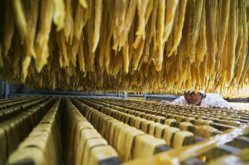 A worker checks on processed soybean food this month in Bijie, China. Soybeans were among China’s top U.S. imports last year. 