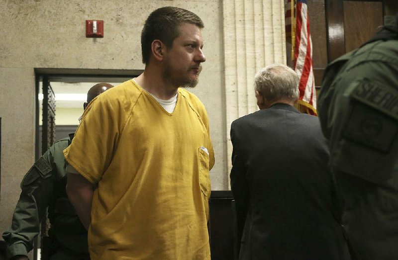 Jason Van Dyke, a former Chicago police officer, is escorted into a Chicago courtroom for his sentencing Friday in the 2014 killing of a teenager. 