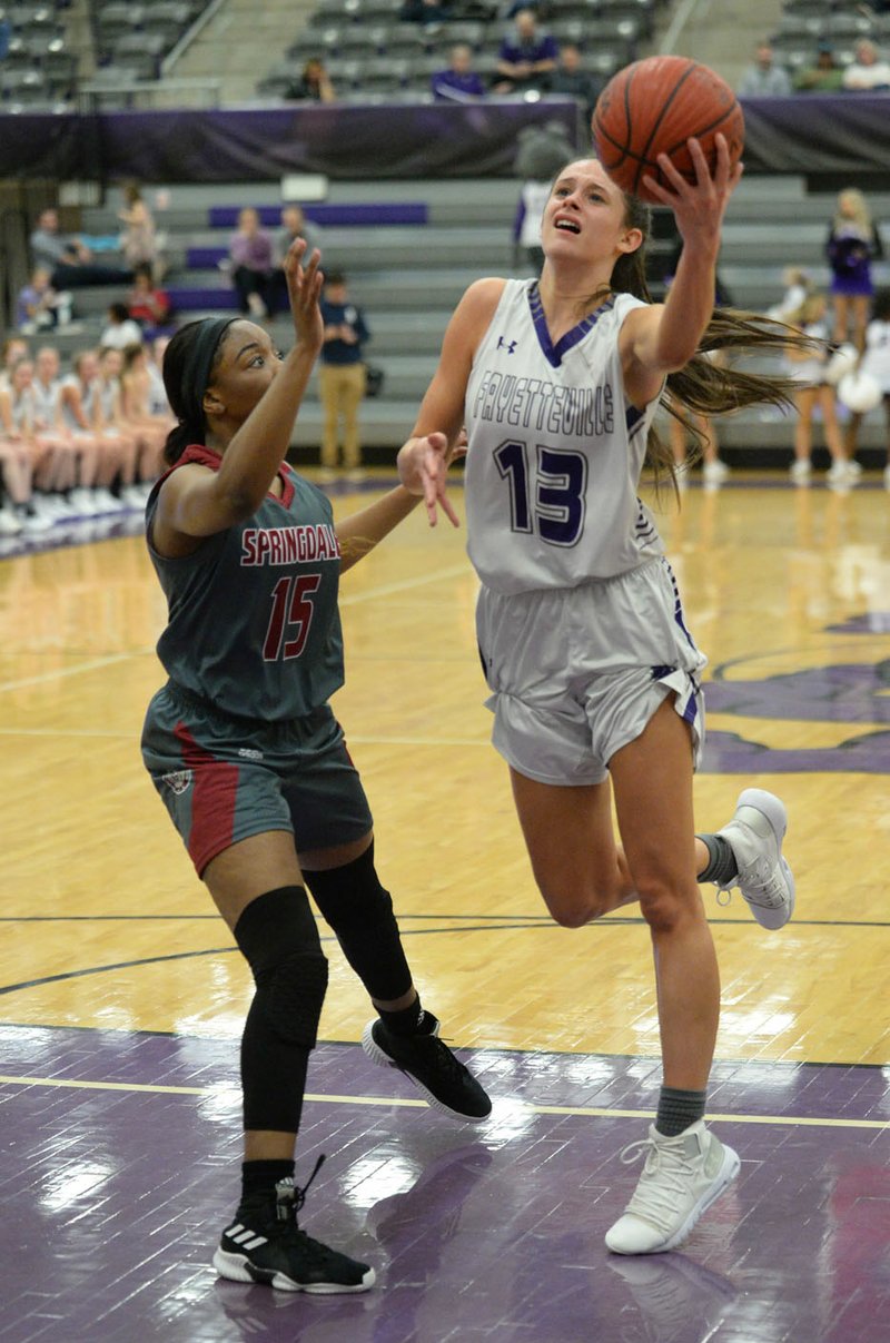 NWA Democrat-Gazette/ANDY SHUPE Fayetteville's Sasha Goforth (13) takes a shot in the lane over Springdale's Ashley Pegue (15) Friday, Jan. 18, 2019, during the first half of play in Bulldog Arena in Fayetteville. Visit nwadg.com/photos to see more photographs from the games.