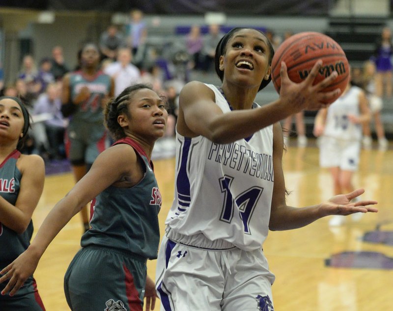 NWA Democrat-Gazette/ANDY SHUPE Fayetteville's Coriah Beck (14) reaches to score over Springdale's Thaly Sysavanh Friday, Jan. 18, 2019, during the first half of play in Bulldog Arena in Fayetteville. Visit nwadg.com/photos to see more photographs from the games.