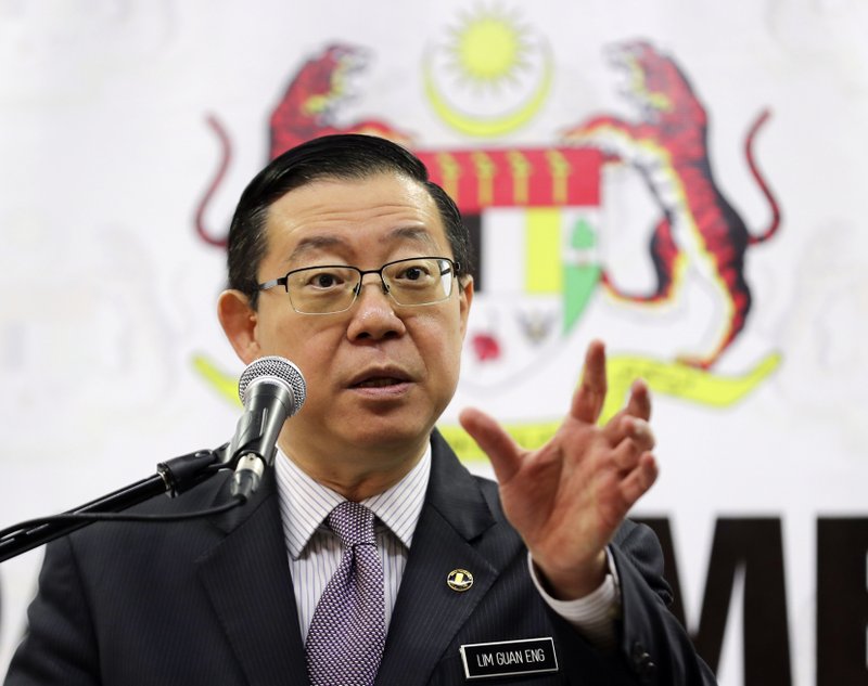 Malaysian Finance Minister Lim Guan Eng gesture during a press conference at Finance Ministry in Putrajaya, Malaysia, Friday, Jan. 18, 2019. Lim said the apology by Goldman Sachs for its role in the alleged multibillion-dollar ransacking of state investment fund 1MDB was insufficient and that it has to pay $7.5 billion as compensation. (AP Photo/Vincent Thian)