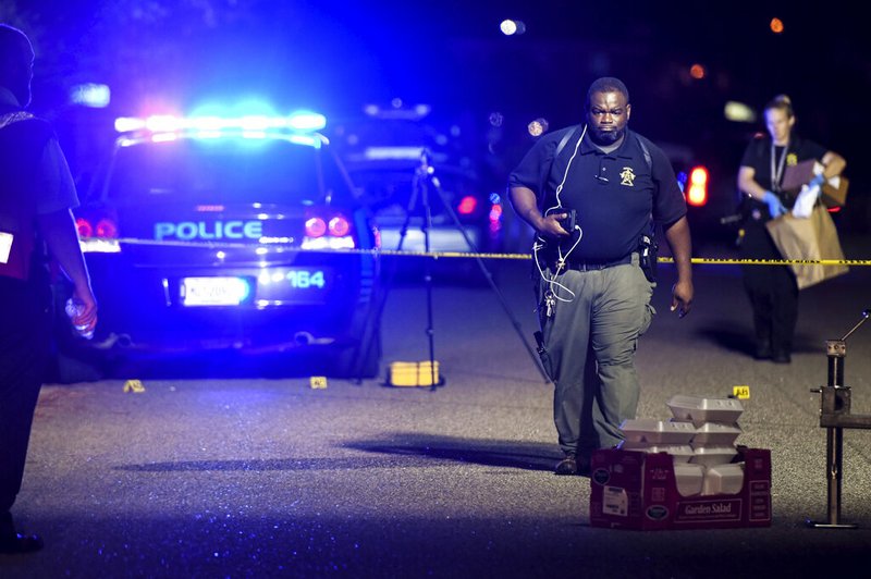 In this Oct. 2, 2018 file photo, a forensics team member exits the crime scene on Ashton Drive in the Vintage Place neighborhood where several members of law enforcement were shot, one fatally in Florence, S.C. State police investigated all but one officer-involved shooting in South Carolina in 2018. But the one they weren't called out for was the most complex and deadliest encounter of all. A proposal in the state Senate would change that.(AP Photo/Sean Rayford, File)