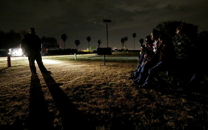 In this June 25, 2014 file photo, a group of immigrants from Honduras and El Salvador, who crossed the U.S.-Mexico border illegally, are stopped in Granjeno, Texas. During the longest-ever government shutdown, the federal judiciary has remained open, allowing the wheels of justice to keep turning in most criminal cases. In November, after a federal judge in California blocked the Trump administration from enforcing a ban on asylum for immigrants who illegally cross the southern border, government attorneys hurriedly asked a federal appeals court, then the U.S. Supreme Court, to suspend the order, terming illegal border crossings an "ongoing and increasing crisis." Both courts denied the government's request. (AP Photo/Eric Gay)
