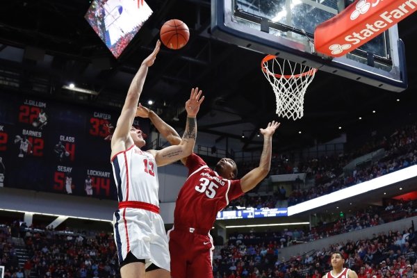 Mississippi center Dominik Olejniczak (13) shoots a hook shot over Arkansas forward Reggie Chaney (35) during the first half of the NCAA college basketball game in Oxford, Miss., Saturday, Jan. 19, 2019. (AP Photo/Rogelio V. Solis)