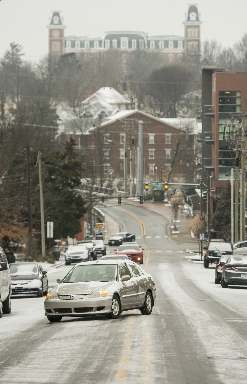 
A car struggles to climb a icy hill Saturday, Jan. 19, 2019, on West Lafayette Street in Fayetteville.  