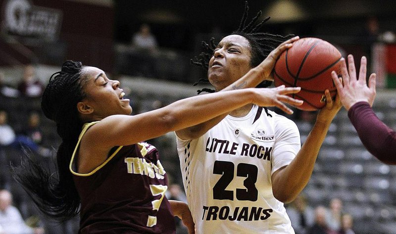 UALR’s Kyra Collier (right) puts up a shot while guarded by Texas State’s Kennedy Taylor during the second quarter of the Lady Trojans’ 62-47 victory Thursday at the Jack Stephens Center in Little Rock. Collier is averaging 14.2 points per game this season.