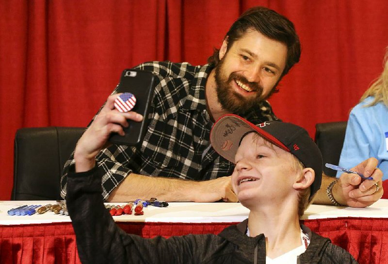 Dylan Howard (right), 13, of Phoenix snaps a selfie with St. Louis Cardinals pitcher Andrew Miller after getting his autograph Saturday at the Cardinals Winter Warm-Up in St. Louis.
