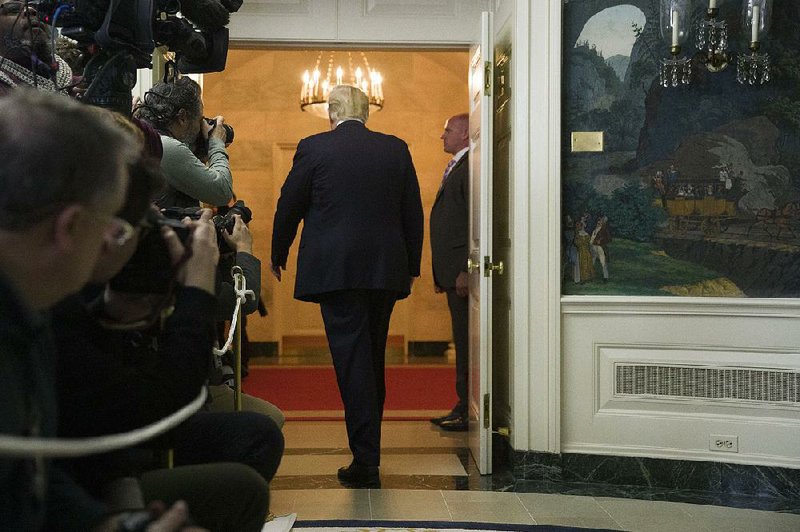 President Donald Trump leaves the Diplomatic Reception Room of the White House on Saturday after saying in a televised address that “both sides in Washington must simply come together” to end the government shutdown. 