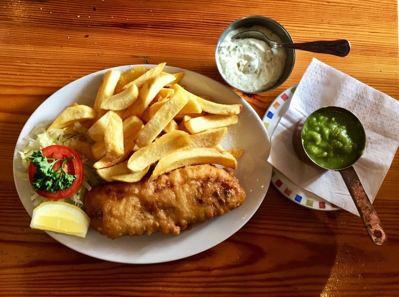 A plate of cod and chips, plus side portions of mushy peas and tartar sauce, at Olley's, a fish-and-chips restaurant in Herne Hill, South London. MUST CREDIT: Photo for The Washington Post by Will Hawkes