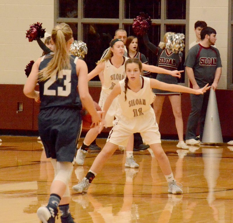 Graham Thomas/Siloam Sunday Greenwood's Kinley Fisher brings the ball up the floor as Siloam Springs sophomore Quincy Efurd gets ready to defend Tuesday at Panther Activity Center. Greenwood defeated Siloam Springs 66-38.