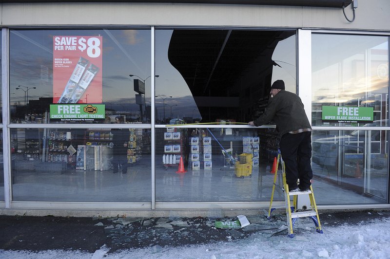 The Associated Press BROKEN WINDOW: In this Nov. 30, 2018, file photo, Dennis Keeling, of Instant Services, measures for a broken window at an auto parts store following an earthquake in Anchorage, Alaska. Seven weeks after the massive earthquake struck Alaska, the seemingly endless aftershocks are keeping many residents filled with anxiety.