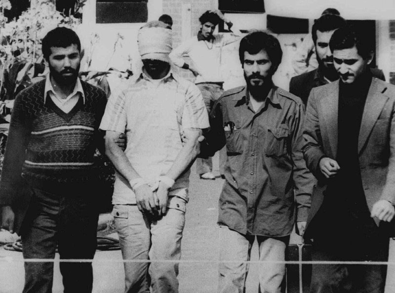 FILE - In this Nov. 9, 1979 file photograph, one of the hostages seized when Islamic radicals stormed the U.S. Embassy in Tehran, blindfolded and with his hands bound, is displayed to a crowd in Tehran, Iran. This climactic event and others in 1979, which dominated television sets and newspaper front pages 40 years ago, helped shape the modern Middle East. (AP Photo, File)