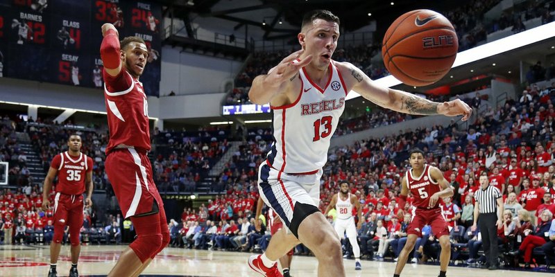 The Associated Press BIG MAN: Ole Miss center Dominik Olejniczak (13) chases a loose ball in front of Arkansas center Daniel Gafford Saturday during the first half of the Rebels' 84-67 win against the Razorbacks in Oxford, Miss.