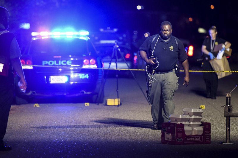 FILE - In this Oct. 2, 2018 file photo, a forensics team member exits the crime scene on Ashton Drive in the Vintage Place neighborhood where several members of law enforcement were shot, one fatally in Florence, S.C. State police investigated all but one officer-involved shooting in South Carolina in 2018. But the one they weren&#x2019;t called out for was the most complex and deadliest encounter of all. A proposal in the state Senate would change that.(AP Photo/Sean Rayford, File)