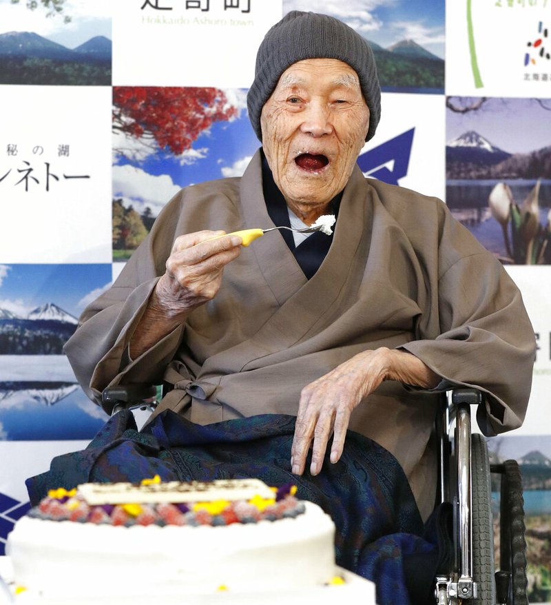 In this April 10, 2018, file photo, Masazo Nonaka eats a cake after receiving the certificate from Guinness World Records as the world's oldest living man at then age 112 years and 259 days during a ceremony in Ashoro on Japan's northern main island of Hokkaido. In the early hours of Sunday, Jan. 20, 2019, Nonaka died at his home _ a hot springs inn _ in northern Japan at the age of 113. (Masanori Takei/Kyodo News via AP)