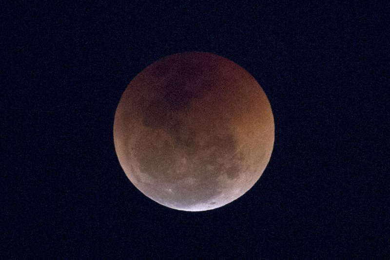 This Friday, July 27, 2018 file photo shows a blood moon lunar eclipse from the Arpoador beach in Rio de Janeiro, Brazil. Starting Sunday evening, all of North and South America will be able to see the only total lunar eclipse of 2019 from start to finish this weekend. (AP Photo/Silvia Izquierdo)

