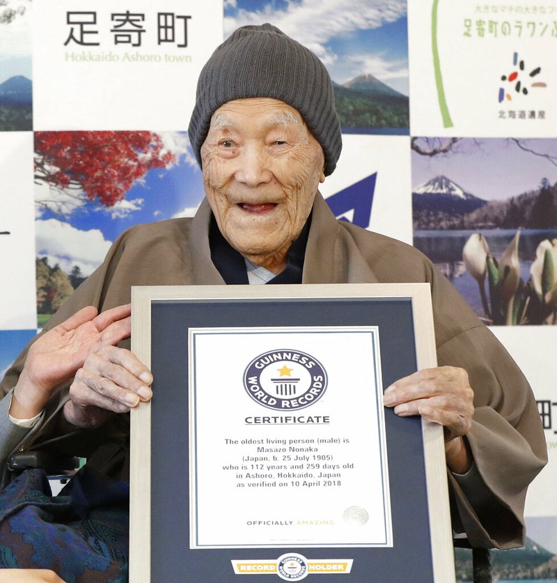 In this April 10, 2018, file photo, Masazo Nonaka eats a cake after receiving the certificate from Guinness World Records as the world's oldest living man at then age 112 years and 259 days during a ceremony in Ashoro on Japan's northern main island of Hokkaido. In the early hours of Sunday, Jan. 20, 2019, Nonaka died at his home, a hot springs inn in northern Japan at the age of 113.