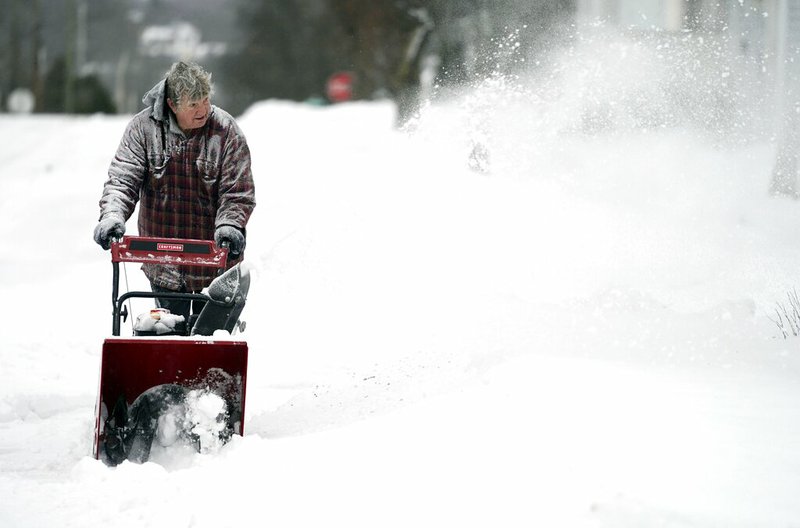 John Ott clears snow on Madison Avenue in Pittsfield, Mass., Sunday, Jan. 20, 2019. A major winter storm that has brought some of the coldest temperatures of the season covered a large swath of the U.S. in snow as it wreaked havoc on air travel and caused slick road conditions throughout New England Sunday. 