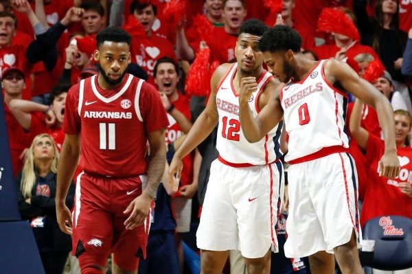 Mississippi forward Bruce Stevens (12) confers with guard Blake Hinson (0) as he kisses his biceps after scoring on a dunk while Arkansas guard Keyshawn Embery-Simpson (11) walks away during the second half of the NCAA college basketball game in Oxford, Miss., Saturday, Jan. 19, 2019. Mississippi won 84-67. (AP Photo/Rogelio V. Solis)