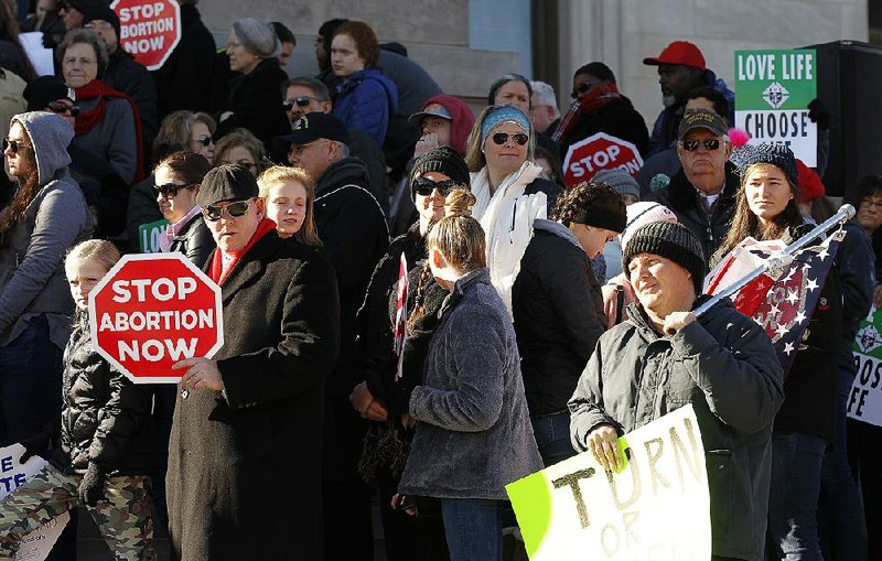 Anti-abortion activists listen to a speaker Sunday during the March for Life rally on the steps of the state Capitol in Little Rock. 