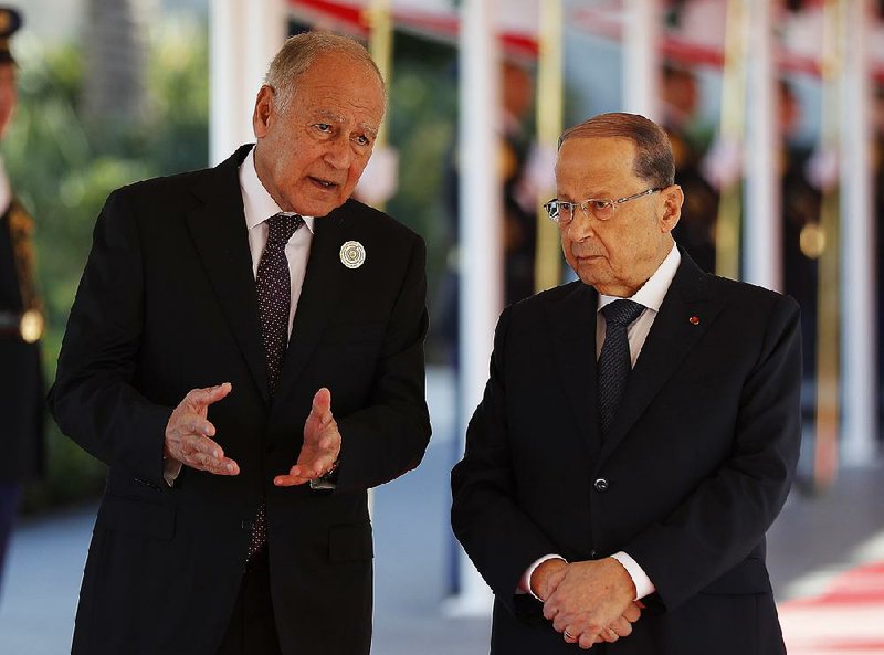 Arab League Secretary-General Ahmed Aboul-Gheit (left) speaks with Lebanese President Michel Aoun on Sunday at Rafik Hariri International Airport in Beirut.