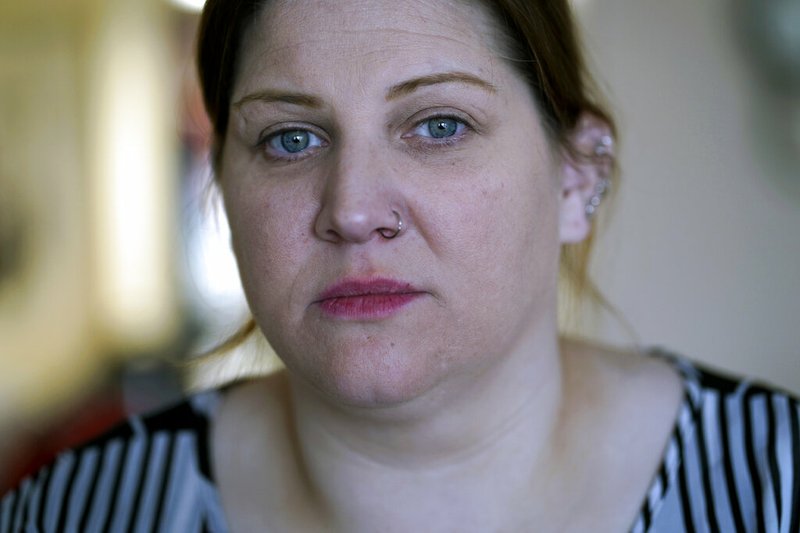 Doris Cochran poses for a portrait in her apartment in Arlington, Va., on Friday, Jan. 18, 2019. Cochran is a disabled mother of two young boys living in subsidized housing in Arlington, Virginia. She's stockpiling canned foods to try to make sure her family won't go hungry if her food stamps run out. She says she just doesn't know "what's going to happen" and that's what scares her the most. (AP Photo/Sait Serkan Gurbuz)