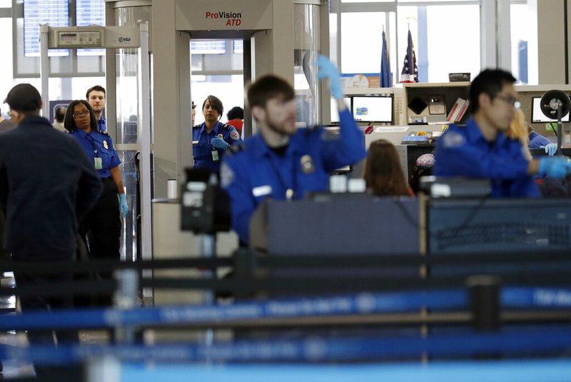 In this Jan. 5, 2019, file photo Transportation Security Administration officers work at a checkpoint at O'Hare airport in Chicago. The percentage of TSA airport screeners missing work has hit 10 percent as the partial government shutdown stretches into its fifth week. The Transportation Security Administration said Monday, Jan. 21, that Sunday’s absence rate compared to 3.1 percent on the comparable Sunday a year ago. (AP Photo/Nam Y. Huh, File)
