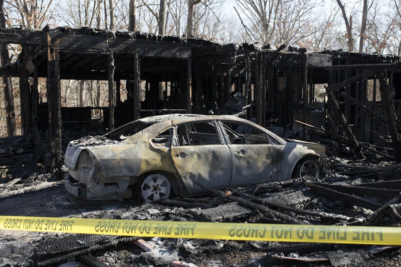 NWA Democrat-Gazette/CHARLIE KAIJO The remains of a house fire is shown, Sunday, January 21, 2019 at a residence on Crosston Lane in Bella Vista. 
