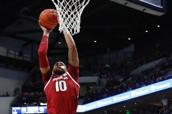 Arkansas forward Daniel Gafford (10) attempts a dunk as Mississippi guard Breein Tyree (4) watches during the second half of the NCAA college basketball game in Oxford, Miss., Saturday, Jan. 19, 2019. Mississippi won 84-67. (AP Photo/Rogelio V. Solis)